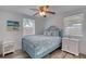 Comfortable bedroom features a ceiling fan, wood-look floors, and neutral paint at 31 River Shore Dr, Ormond Beach, FL 32176