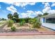 View of the well-maintained, xeriscaped front yard with charming decorative touches at 31 River Shore Dr, Ormond Beach, FL 32176