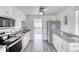 Modern kitchen with stainless steel appliances, granite countertops, and ample cabinet space at 31 River Shore Dr, Ormond Beach, FL 32176