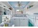 Practical laundry room with a washer, dryer, and ample shelving for storage at 31 River Shore Dr, Ormond Beach, FL 32176