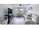 Bright living room featuring a comfortable sofa, stylish furniture, and a view of the outdoors at 31 River Shore Dr, Ormond Beach, FL 32176