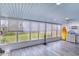 Bright and airy sunroom with large windows, a blue ceiling, and coastal-themed decor at 31 River Shore Dr, Ormond Beach, FL 32176