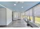 Inviting sunroom featuring light wood flooring, a blue ceiling, and lots of natural light at 31 River Shore Dr, Ormond Beach, FL 32176