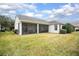 Spacious backyard featuring a screened patio, lush green lawn, and well-maintained landscaping at 319 Bellingrath Ter, Deland, FL 32724