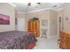 Bedroom featuring wooden furniture, a large dresser, and a view into the bathroom at 319 Bellingrath Ter, Deland, FL 32724