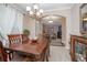Elegant dining room with a wood table and decor; view of living area at 319 Bellingrath Ter, Deland, FL 32724