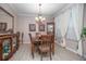 Elegant dining room featuring neutral walls, wood floors, a decorative hutch, and chandelier at 319 Bellingrath Ter, Deland, FL 32724