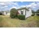 Charming home exterior with beautiful landscaping, well-manicured shrubs, and healthy green lawn at 319 Bellingrath Ter, Deland, FL 32724