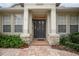 Inviting front entrance featuring a stylish door, sidelights and a brick walkway at 319 Bellingrath Ter, Deland, FL 32724