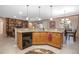 Open kitchen with granite countertops, wood cabinetry, and a view of living spaces at 319 Bellingrath Ter, Deland, FL 32724