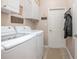 Laundry room equipped with modern LG appliances and overhead storage at 319 Bellingrath Ter, Deland, FL 32724