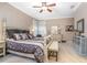 Main bedroom features a four-poster bed, neutral carpet, ceiling fan, and ample natural light from the adjacent window at 319 Bellingrath Ter, Deland, FL 32724