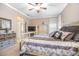 Main bedroom features a decorative ceiling fan, neutral carpet, and a TV on the wall opposite the bed at 319 Bellingrath Ter, Deland, FL 32724