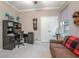 Office featuring a built-in desk and storage, a comfortable sofa and a large window at 319 Bellingrath Ter, Deland, FL 32724
