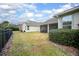 Well-maintained backyard with a black metal fence, lawn, and view of the screened patio at 319 Bellingrath Ter, Deland, FL 32724