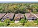 An aerial view of a home with a well-maintained lawn and mature trees in a suburban neighborhood at 320 W Victoria Trails Blvd, Deland, FL 32724