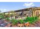 View of the screened lanai with outdoor furniture, lush landscaping, and garden decor at 320 W Victoria Trails Blvd, Deland, FL 32724