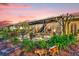 View of the screened lanai with outdoor furniture, lush landscaping, and garden decor at 320 W Victoria Trails Blvd, Deland, FL 32724
