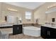 Elegant bathroom featuring dual vanities and a luxurious soaking tub at 320 W Victoria Trails Blvd, Deland, FL 32724