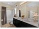 Spacious bathroom featuring a double vanity, decorative accents, and shower-tub combination at 320 W Victoria Trails Blvd, Deland, FL 32724