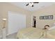 Cozy bedroom includes a ceiling fan, a wardrobe, and soft, neutral decor at 320 W Victoria Trails Blvd, Deland, FL 32724