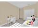 Neutral bedroom with carpet flooring, features a white closet and modern study area at 320 W Victoria Trails Blvd, Deland, FL 32724