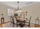 Charming dining room with seating for six and decorative chandelier at 320 W Victoria Trails Blvd, Deland, FL 32724