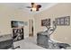Versatile room with an elliptical machine, an office space, and an entertainment area at 320 W Victoria Trails Blvd, Deland, FL 32724