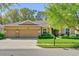 Charming home featuring a three-car garage, manicured lawn, and decorative stone accents at 320 W Victoria Trails Blvd, Deland, FL 32724