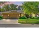 Charming home featuring a three-car garage, manicured lawn, and decorative stone accents at 320 W Victoria Trails Blvd, Deland, FL 32724