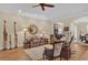 Spacious living room showcasing hardwood floors, comfortable seating, and a decorative mirror at 320 W Victoria Trails Blvd, Deland, FL 32724