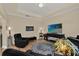 Comfortable living room with hardwood floors, large TV, and black leather seating at 320 W Victoria Trails Blvd, Deland, FL 32724