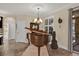 Elegant living room with a grand piano, chandelier, and tile flooring at 320 W Victoria Trails Blvd, Deland, FL 32724