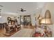 Spacious living room showcasing hardwood floors, comfortable seating, and sliding glass doors to the outside at 320 W Victoria Trails Blvd, Deland, FL 32724