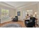Inviting living room with hardwood floors, bright window, and leather armchairs at 320 W Victoria Trails Blvd, Deland, FL 32724