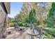 Beautifully landscaped backyard patio with table, lounge chair, and fountain surrounded by lush plants at 320 W Victoria Trails Blvd, Deland, FL 32724