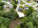 A home sits on a spacious lot with a long driveway leading to a detached three-car garage and privacy fence at 3210 Whitehorse Ct, Deltona, FL 32738
