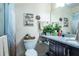 This bathroom features modern decor and dark cabinets at 3210 Whitehorse Ct, Deltona, FL 32738