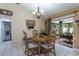 Cozy dining room with natural light, an elegant chandelier and a sliding glass door to the lanai at 3210 Whitehorse Ct, Deltona, FL 32738