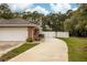 Brick home featuring an attached two-car garage and a private fenced yard at 3210 Whitehorse Ct, Deltona, FL 32738