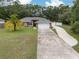 Charming single-story home boasts a well-maintained lawn, long driveway, and attached two-car garage at 3210 Whitehorse Ct, Deltona, FL 32738