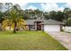 Charming single-story home boasts a brick facade, manicured lawn, mature landscaping, and an attached two-car garage at 3210 Whitehorse Ct, Deltona, FL 32738
