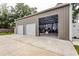 Spacious three-car garage with a paved driveway and well-manicured lawn; perfect for car enthusiasts at 3210 Whitehorse Ct, Deltona, FL 32738