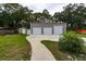 Three-car detached garage, concrete pad, and storage shed nestled within a private, tree-lined backyard at 3210 Whitehorse Ct, Deltona, FL 32738
