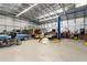 Large garage interior equipped with a car lift and ample space for tools and vehicles at 3210 Whitehorse Ct, Deltona, FL 32738