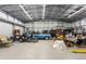 Large garage interior equipped with a car lift and ample space for tools and vehicles at 3210 Whitehorse Ct, Deltona, FL 32738
