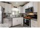 Updated kitchen with stainless steel appliances, modern backsplash, and ample cabinet space at 3210 Whitehorse Ct, Deltona, FL 32738