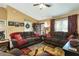 Inviting living room featuring vaulted ceiling, warm colors, plush sofas, and front door access at 3210 Whitehorse Ct, Deltona, FL 32738