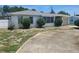 Single story home with light colored roof and rounded bushes in front of the windows at 327 Frances Ter, Daytona Beach, FL 32118
