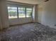 Empty living room with large windows and a doorway to the adjacent room at 327 Frances Ter, Daytona Beach, FL 32118